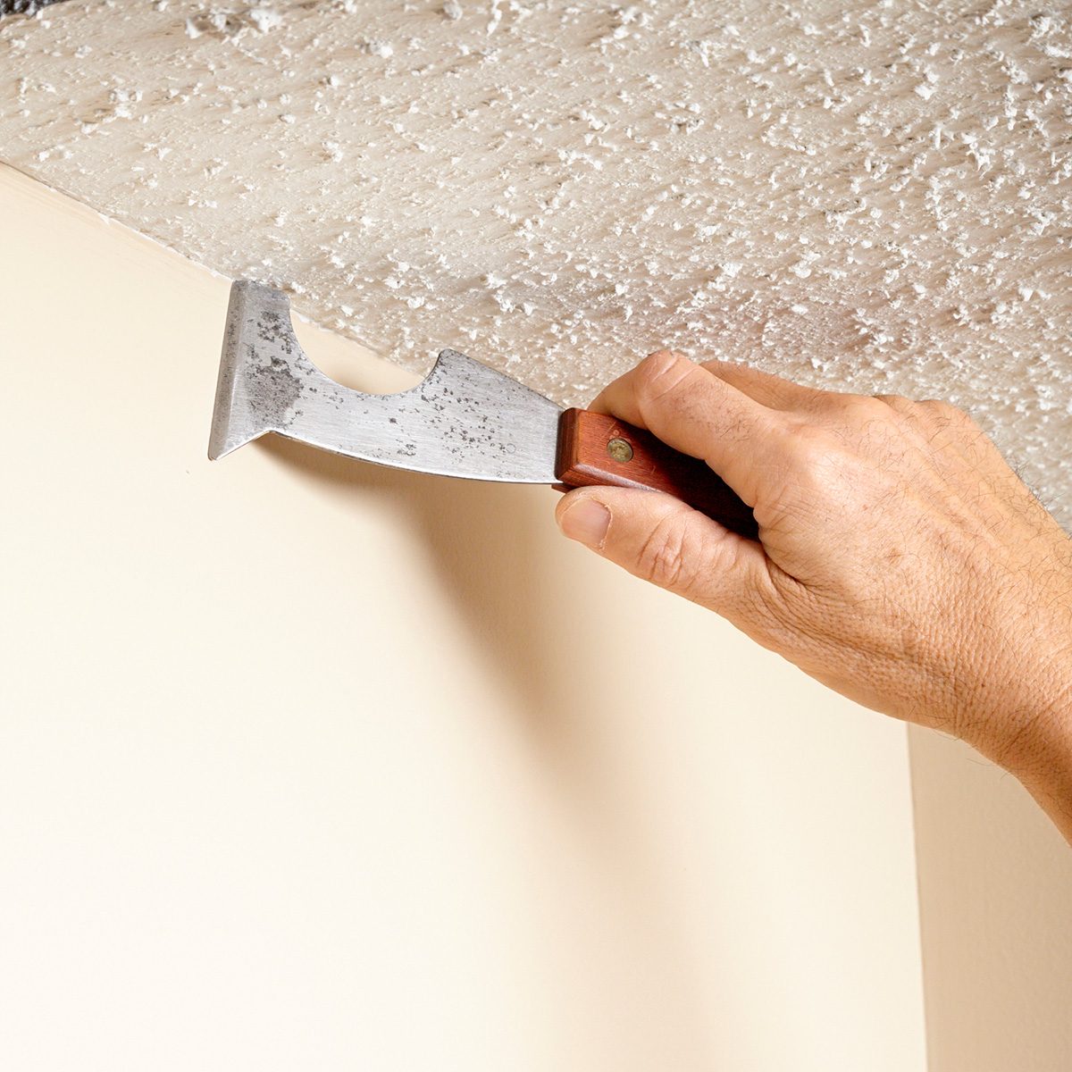 Clearing out popcorn along the ceiling line | Construction Pro Tips