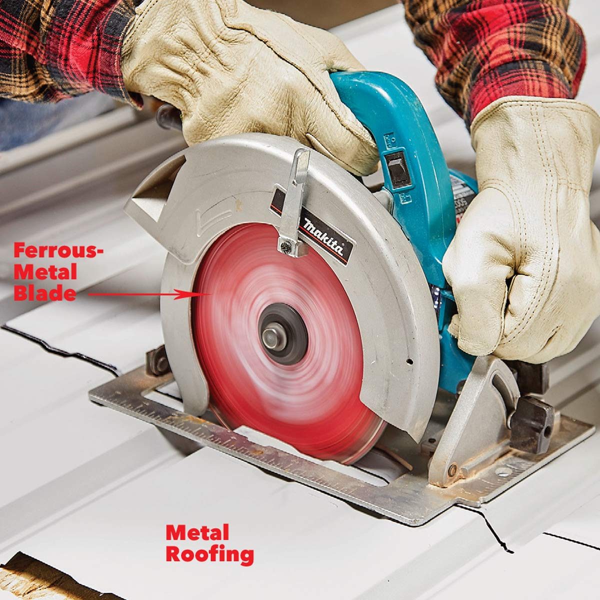 A circular saw with a ferrous-metal blade cuts through metal roofing, held securely by gloved hands, on a flat surface.