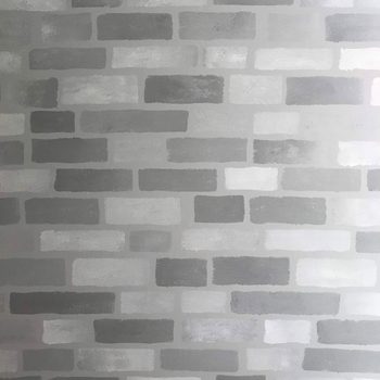 A gray wall features a pattern of various shades of gray bricks, evenly spaced, creating a textured, minimalistic background appearance.