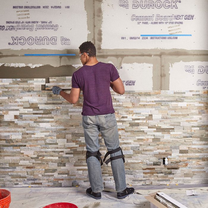 Laying the stone further and further up the wall