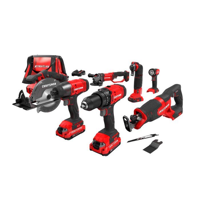 A set of red and black Craftsman power tools, including a circular saw, drill, and flashlight, arranged with batteries and accessories on a plain background.