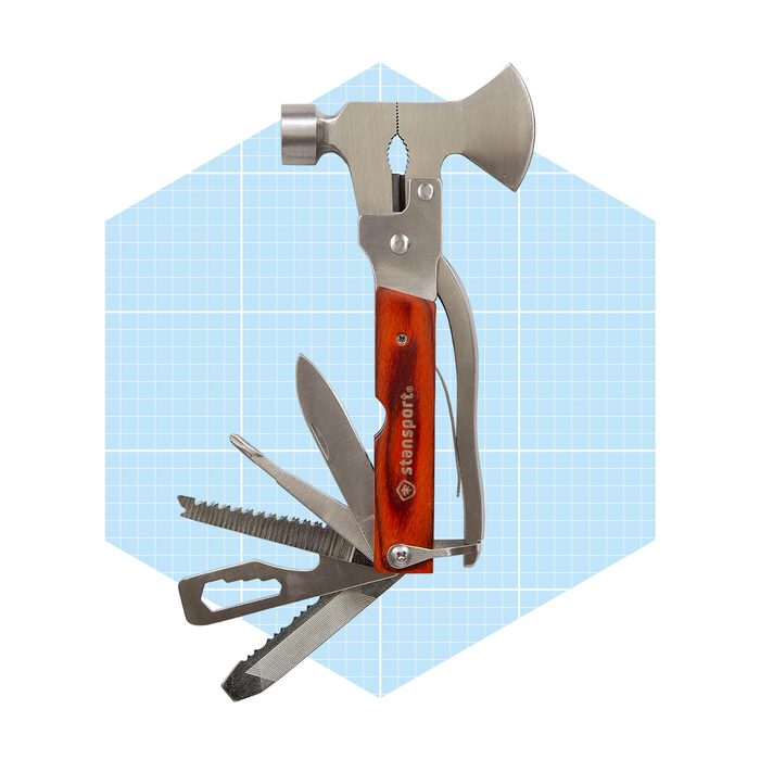 A multi-tool with a hammer, pliers, and various blades is displayed against a light blue grid background. It combines multiple functions in one compact design.