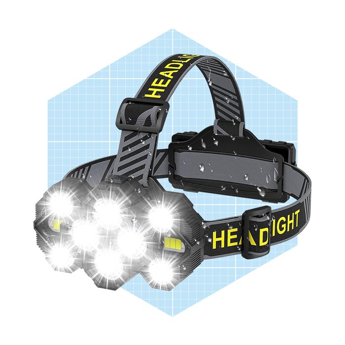 A waterproof headlamp with multiple bright LEDs is secured by an adjustable strap, designed for illuminating dark environments during activities like camping or repair work.