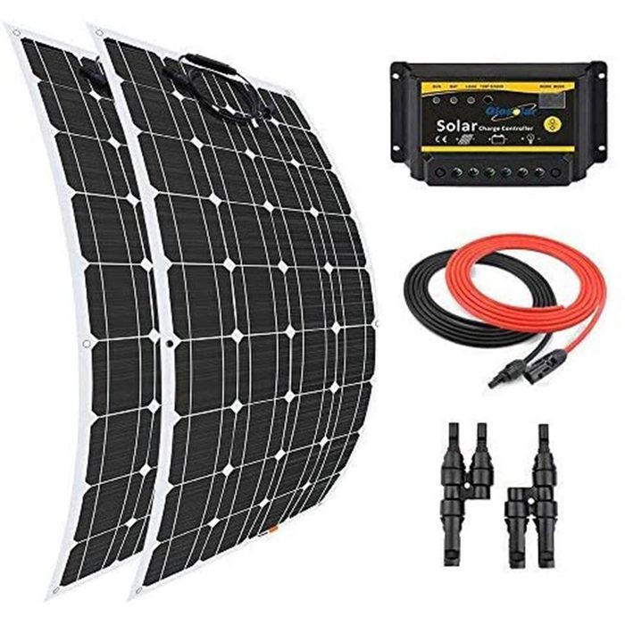 Two curved solar panels lie beside a solar charge controller and cables. The setup is for harnessing solar energy, likely in an outdoor environment.