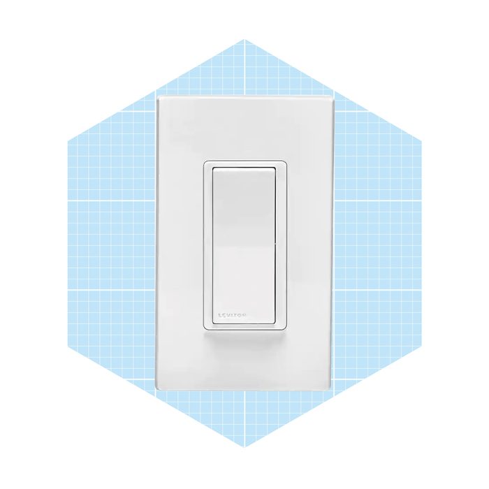 A white light switch is mounted on a wall, engaged in the action of being turned on or off, set against a light blue grid background.