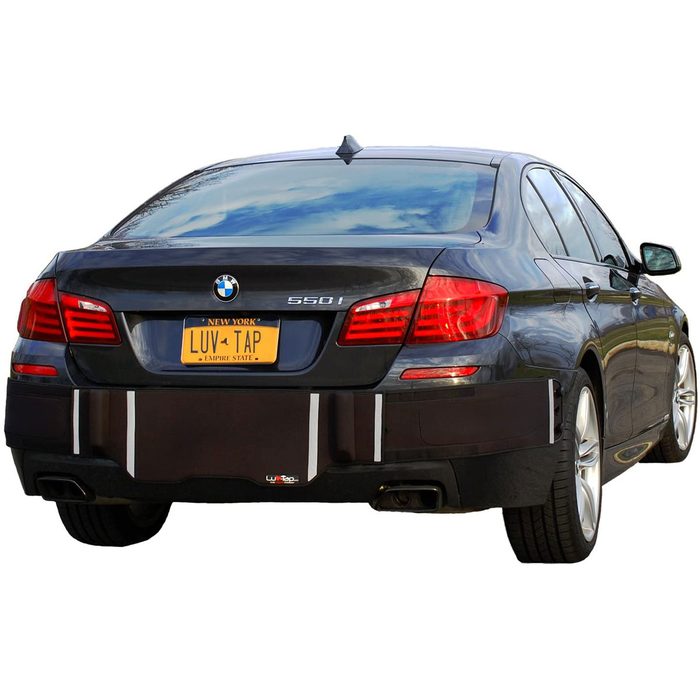 A black BMW 550i with a custom bumper protector displays a yellow license plate reading 