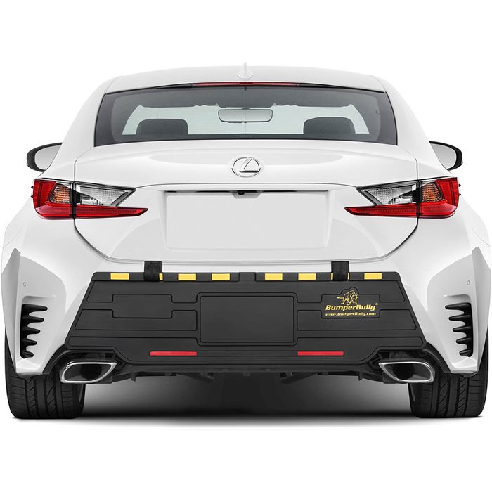 A white Lexus vehicle with a black bumper protector mounted on the rear, featuring yellow and red stripes for visibility.