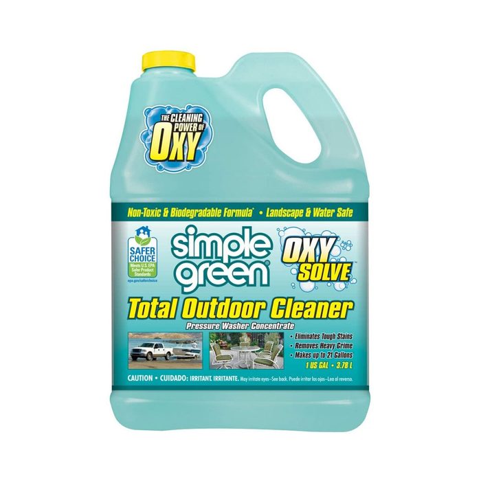 A gallon container of Simple Green Oxy Solve Total Outdoor Cleaner sits upright, designed for pressure washing, featuring bright turquoise coloring and labeled benefits.