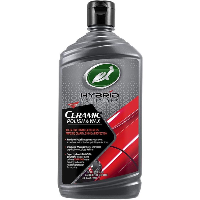A bottle of ceramic polish and wax stands upright, showcasing its sleek design and branding. It promises clarity, shine, and protection for automotive surfaces.