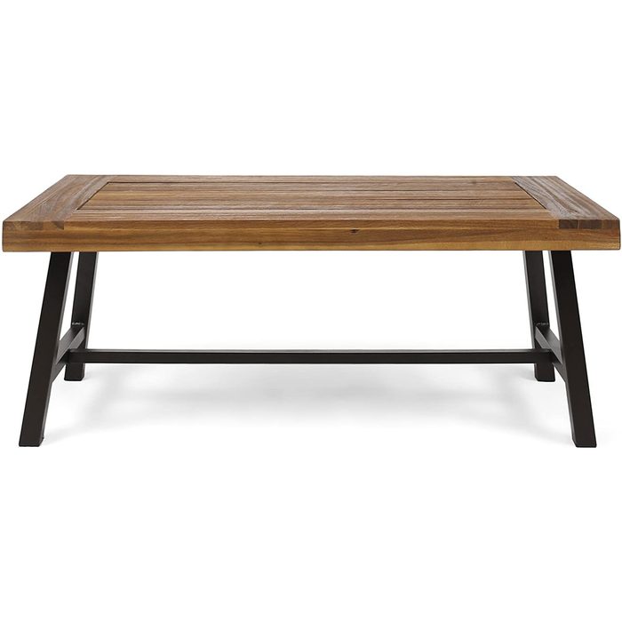 A wooden coffee table with a slatted top is supported by black metal legs, positioned on a plain background, inviting use in a living space.