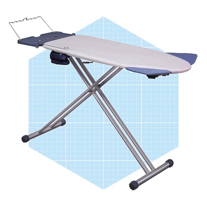 An ironing board stands upright, showcasing a flat surface for pressing clothes, set against a light blue grid-patterned background.
