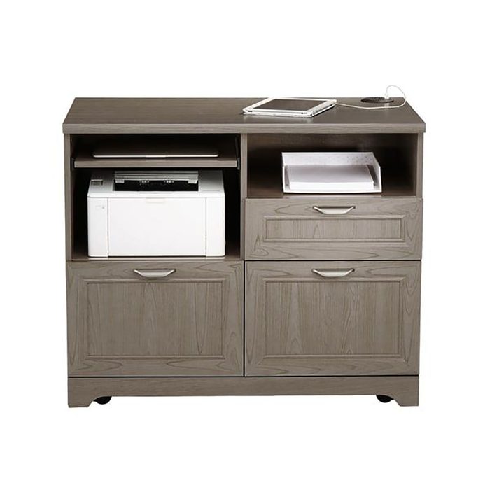 A gray wooden cabinet contains a printer and storage drawers. A tablet rests on top, with a charging cable visible, set in a neutral environment.