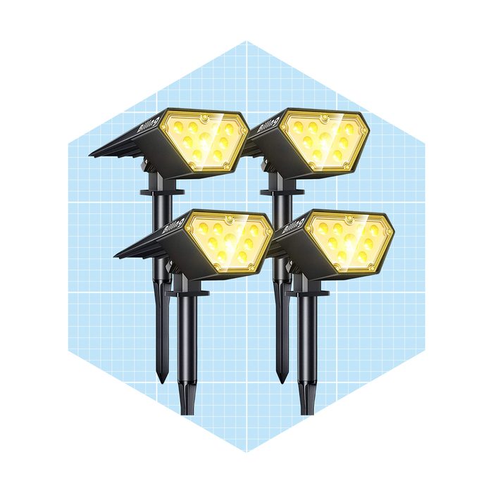 Four decorative lights are positioned upright, illuminating with yellow glow, set against a subtle blue grid background.