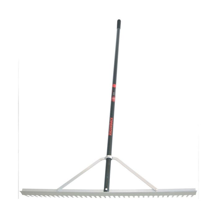 A metal rake with a long handle is positioned upright and features serrated edges for gathering materials, typically used in gardening or landscaping.