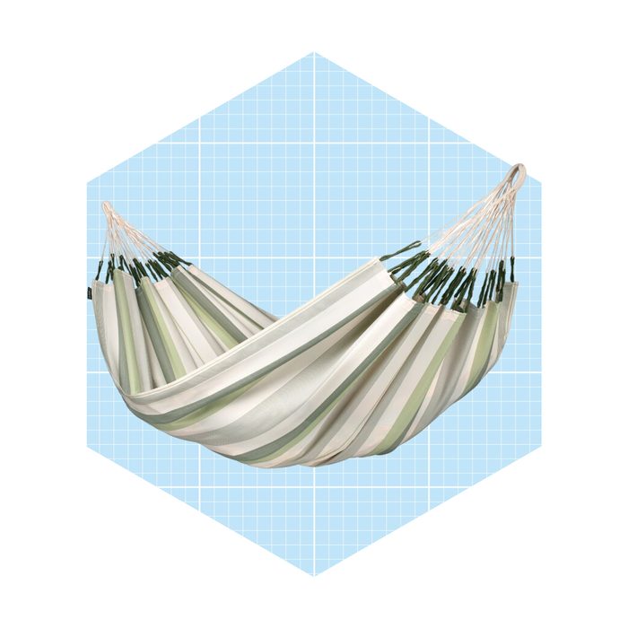 A striped hammock hangs in a relaxed position. The background features a light blue grid pattern, suggesting a serene outdoor setting.