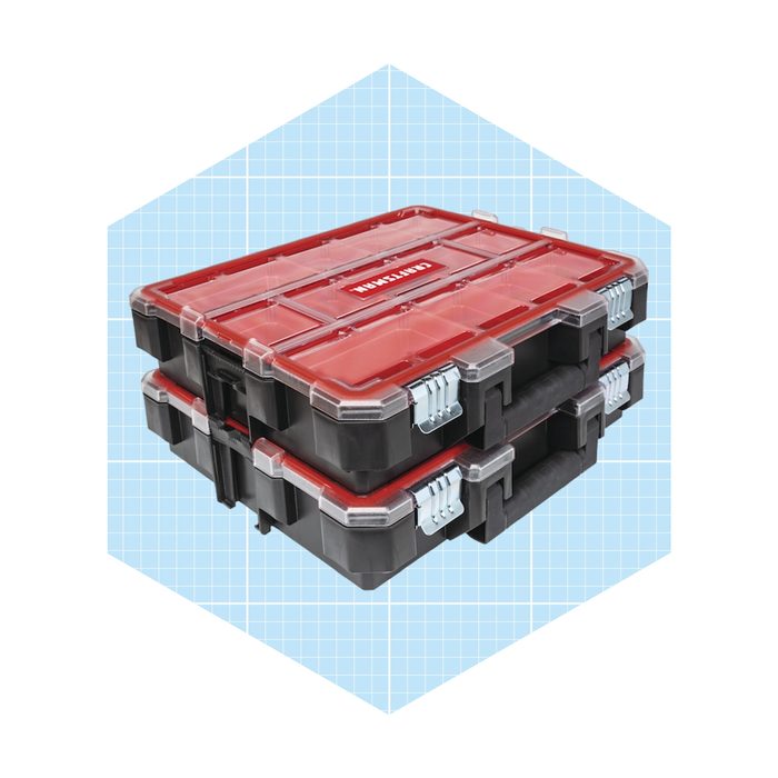 Two stacked storage boxes with transparent red lids and black bases sit against a light blue grid background, designed for organizing tools or materials.