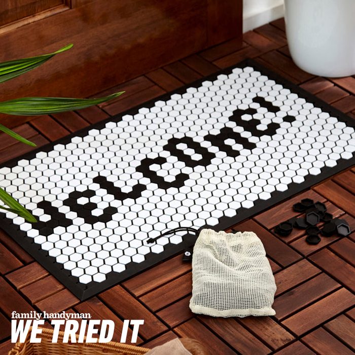 A decorative doormat displays 