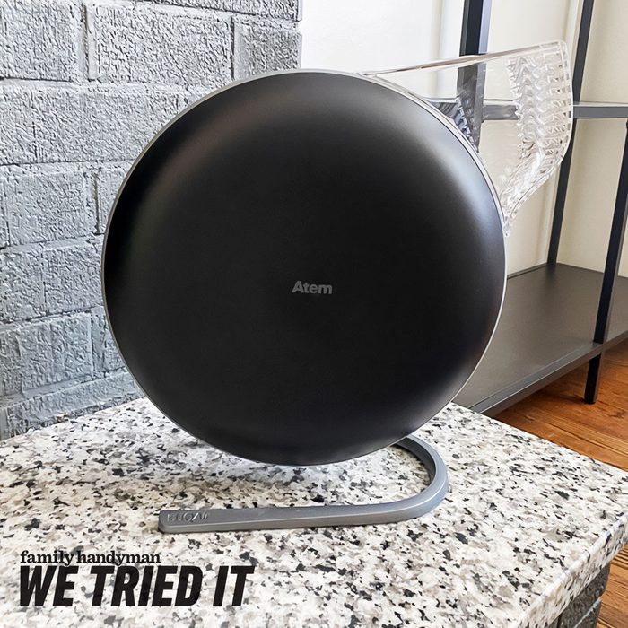 A round black device labeled 