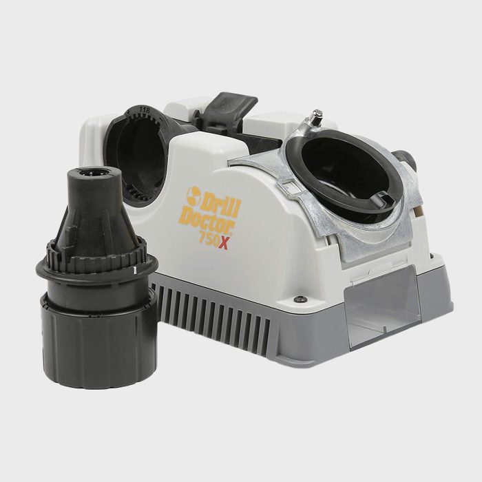 A drill sharpening machine with a black attachment next to it, designed for enhancing drill bit performance in a workshop setting.