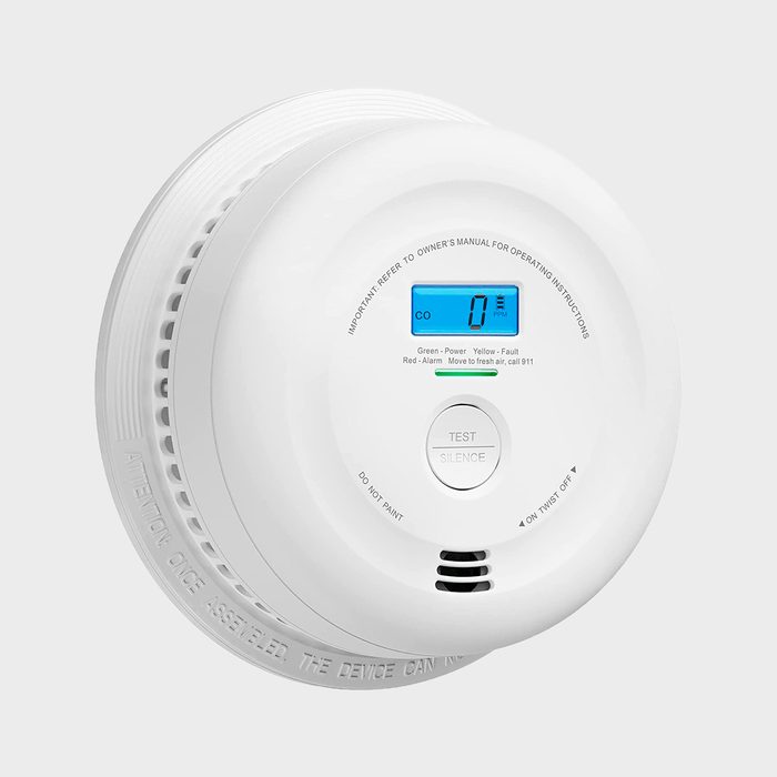 A white carbon monoxide detector displays a digital readout showing 