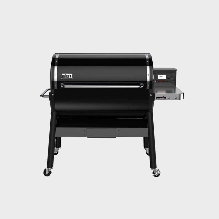 A black pellet grill sits on wheeled legs, featuring a digital display and side shelf, designed for outdoor cooking and smoking.