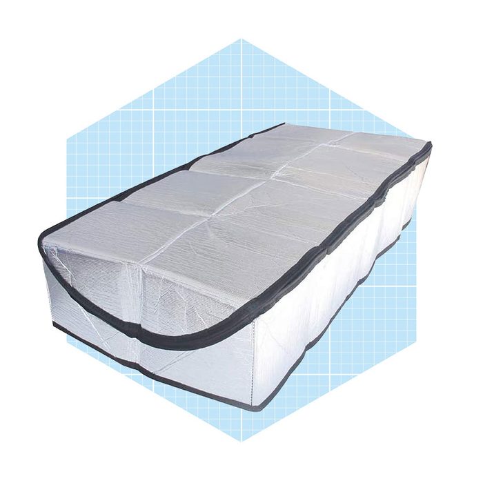 A rectangular storage bag is displayed on a light blue grid background, featuring a transparent design with a black zipper and edging, intended for organizing items.