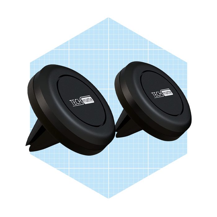 Two circular black phone mounts are positioned upright, designed to secure devices in a car's air vent, set against a light blue grid background.