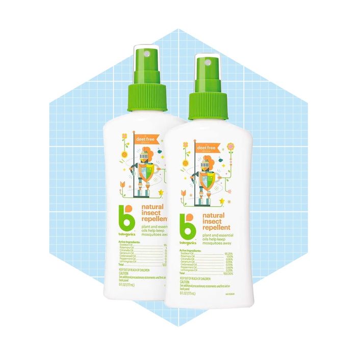 Two spray bottles of natural insect repellent sit against a light blue geometric background, promoting a deet-free formula with plant extracts for mosquito protection.