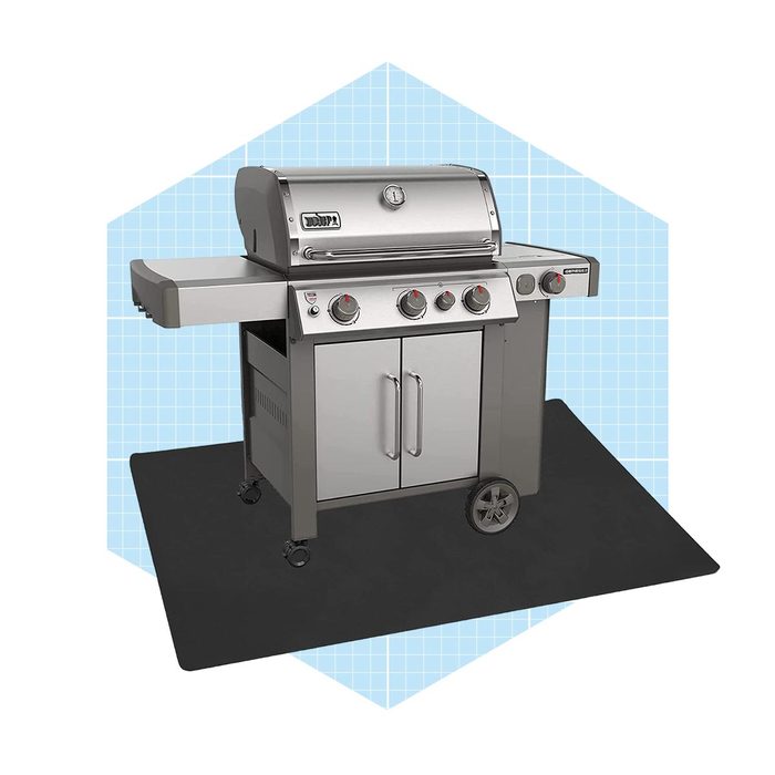 A stainless steel gas grill sits on a black mat, featuring burners and a storage cabinet, against a light blue geometric background.