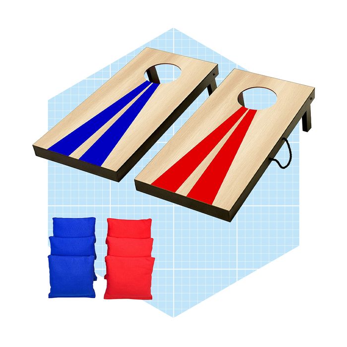 Two cornhole boards, one blue and one red, are placed on a light blue grid background, accompanied by sets of blue and red bean bags.