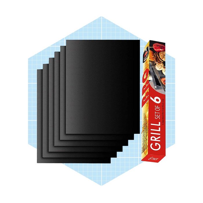 A set of six black grilling mats is stacked vertically beside a colorful box labeled 