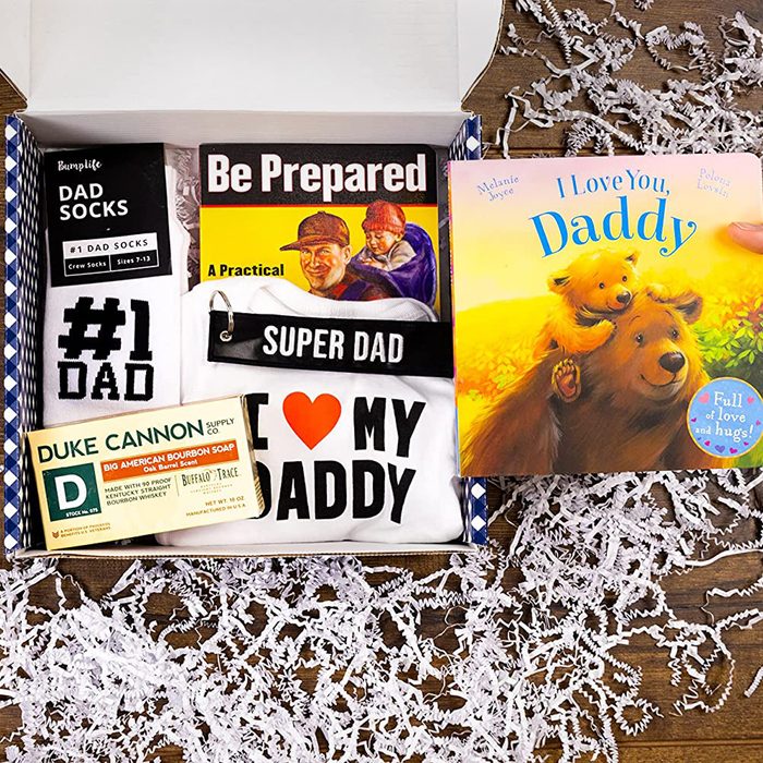 A gift box contains dad-themed items: socks labeled 