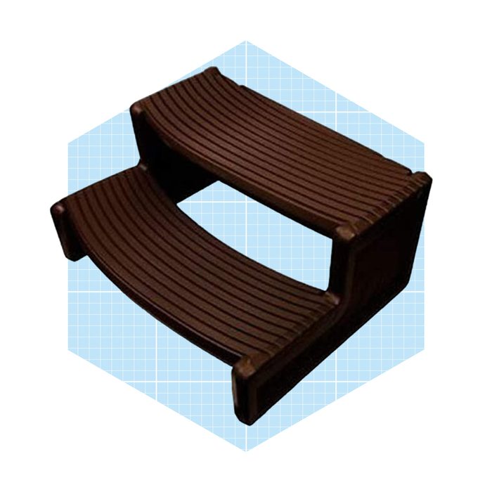 A two-step stool with textured surfaces provides elevation. It is set against a light blue grid background, adding visual contrast.