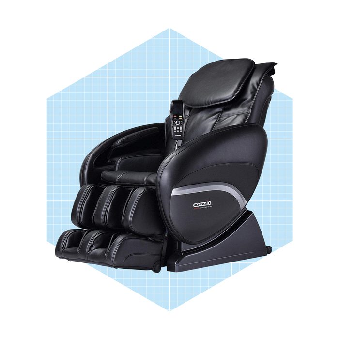A black massage chair is positioned upright, featuring a remote control on the side, set against a light blue grid background.
