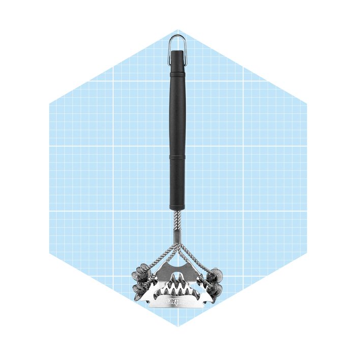 A metal garden tool with a black handle is positioned upright, equipped with claw-like tines, set against a light blue grid background.