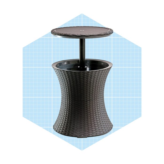 A black, woven-pattern table stands upright with a circular top and frame, situated against a light blue, grid-pattern background.