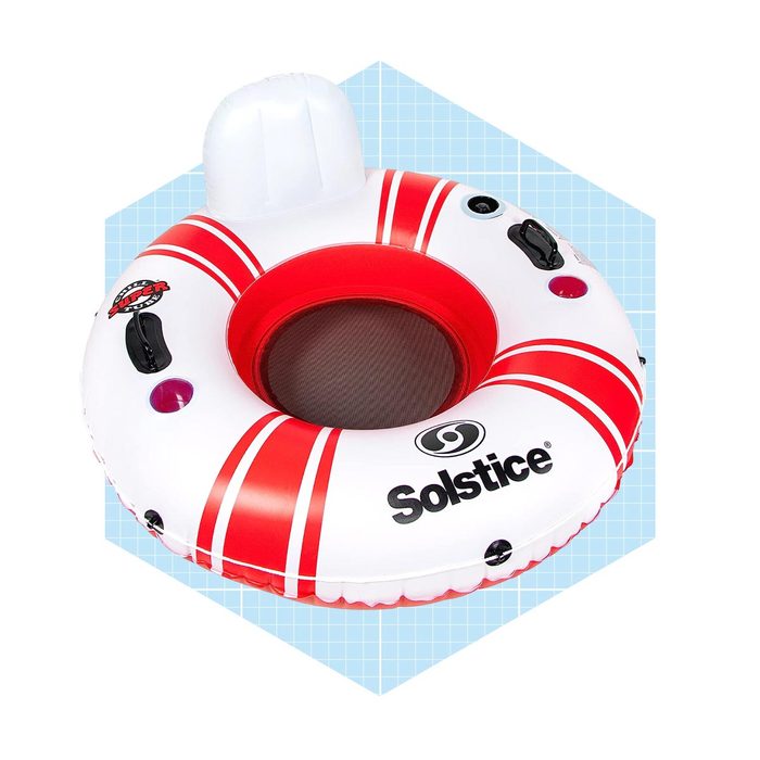 An inflatable inner tube with red and white stripes rests against a light blue background, designed for floating in water for leisure.