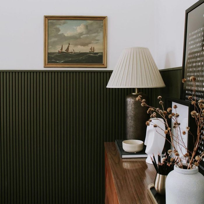 A room with wall painting with skinny vertical slats