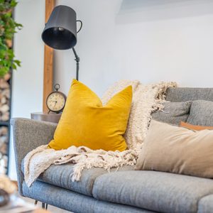 sofa with blanket and throw pillows