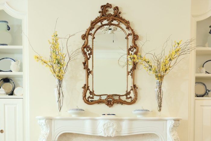 Ornate period living room with mirror over fireplace