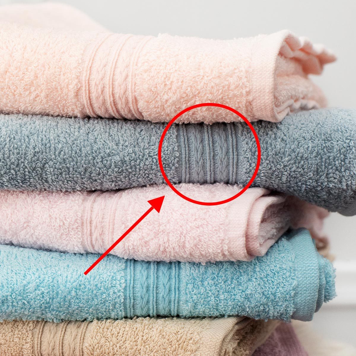 Stack of clean soft colorful towels with graphic treatment