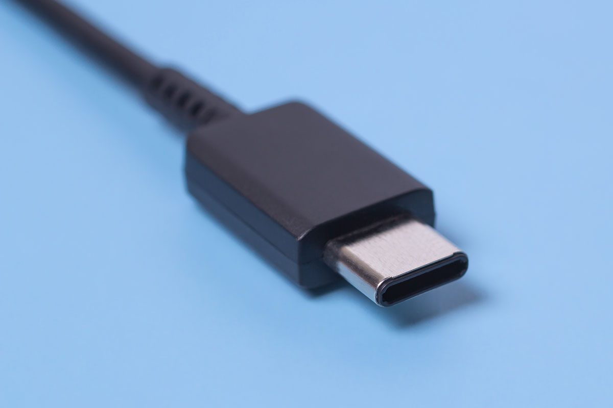 Close up photo of usb type c connector on blue blurred background.