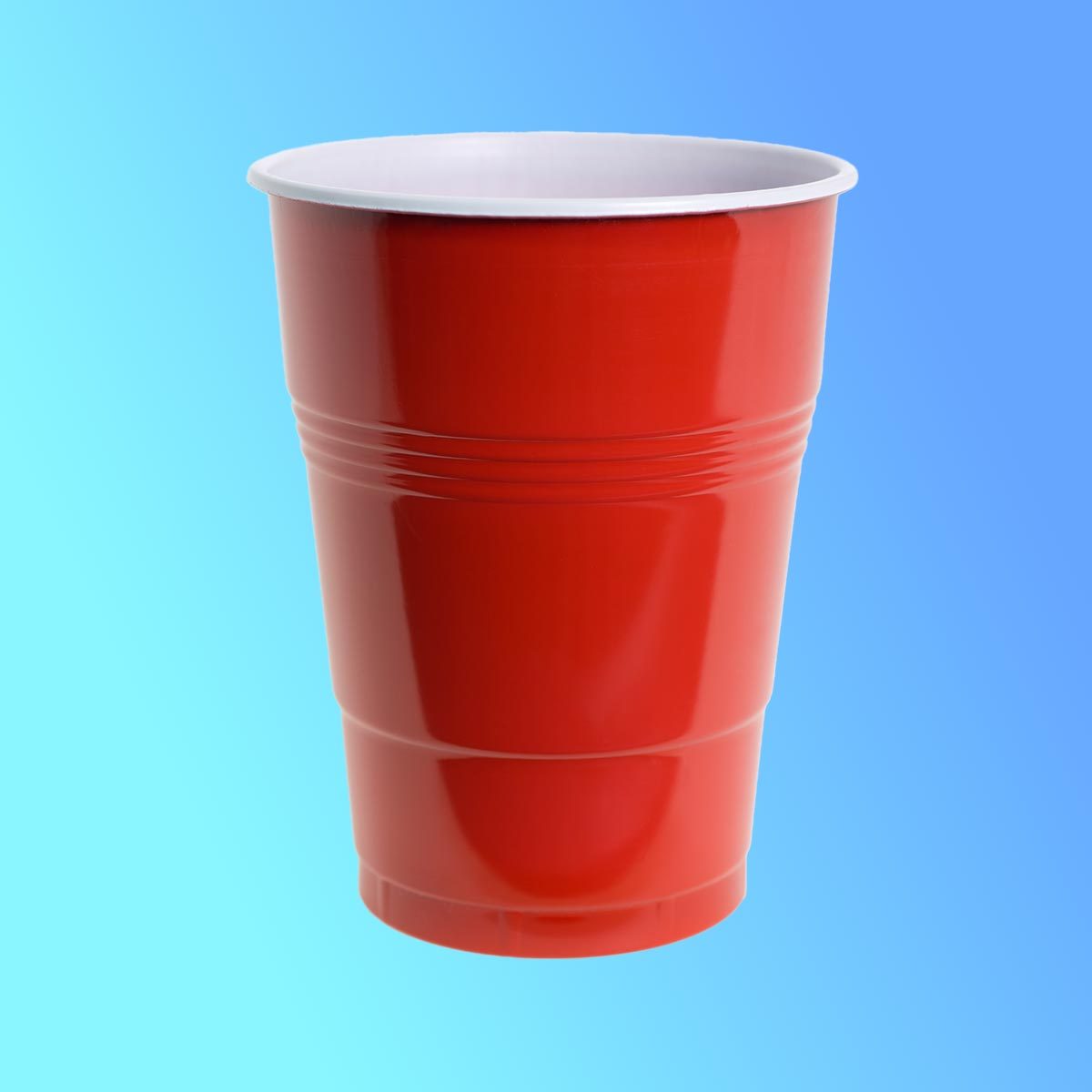 Red solo plastic cup close up on a blue background
